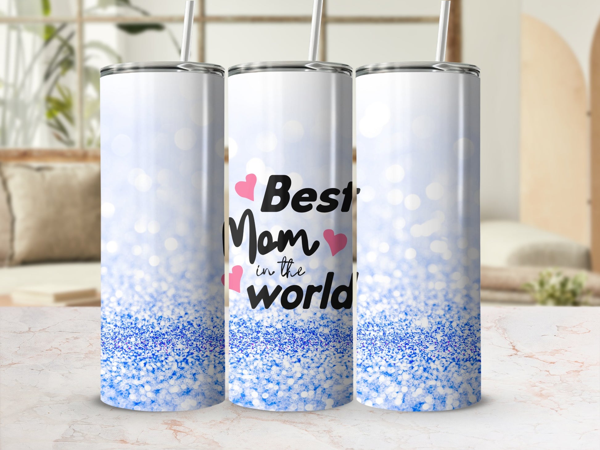 Three tumblers with "Best Mom in the World" text and blue glitter design.
