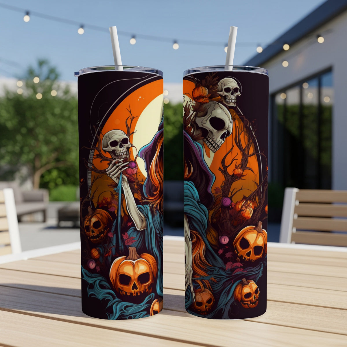 Two tumblers with Halloween-themed art featuring skeletons, pumpkins, and gnarled trees.