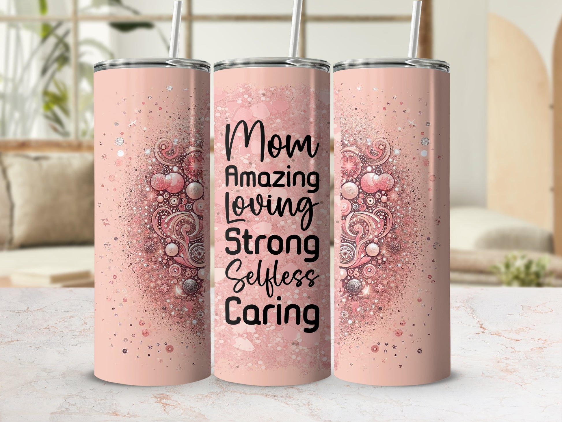 Pink tumbler with "Mom Amazing Loving Strong Selfless Caring" text and glitter details.