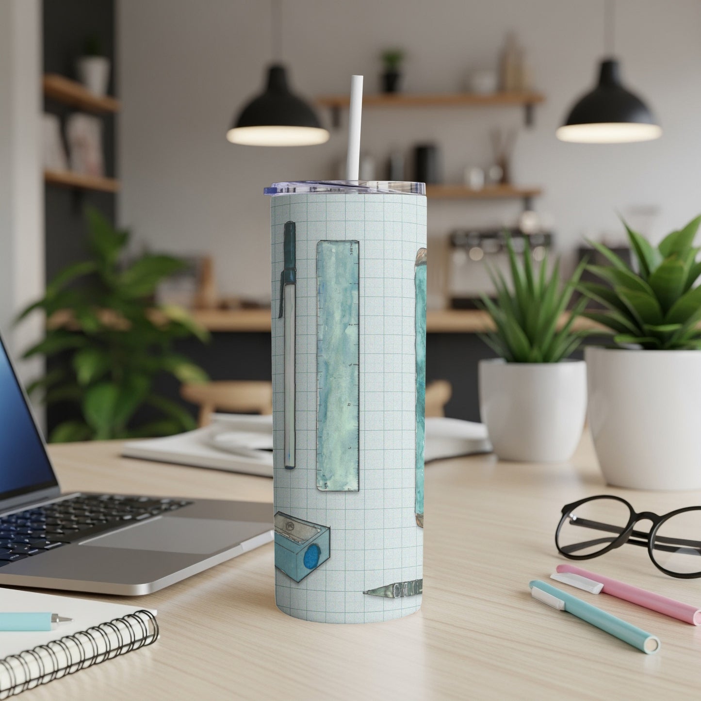 Ruler and pencil art on a white tumbler with a straw.