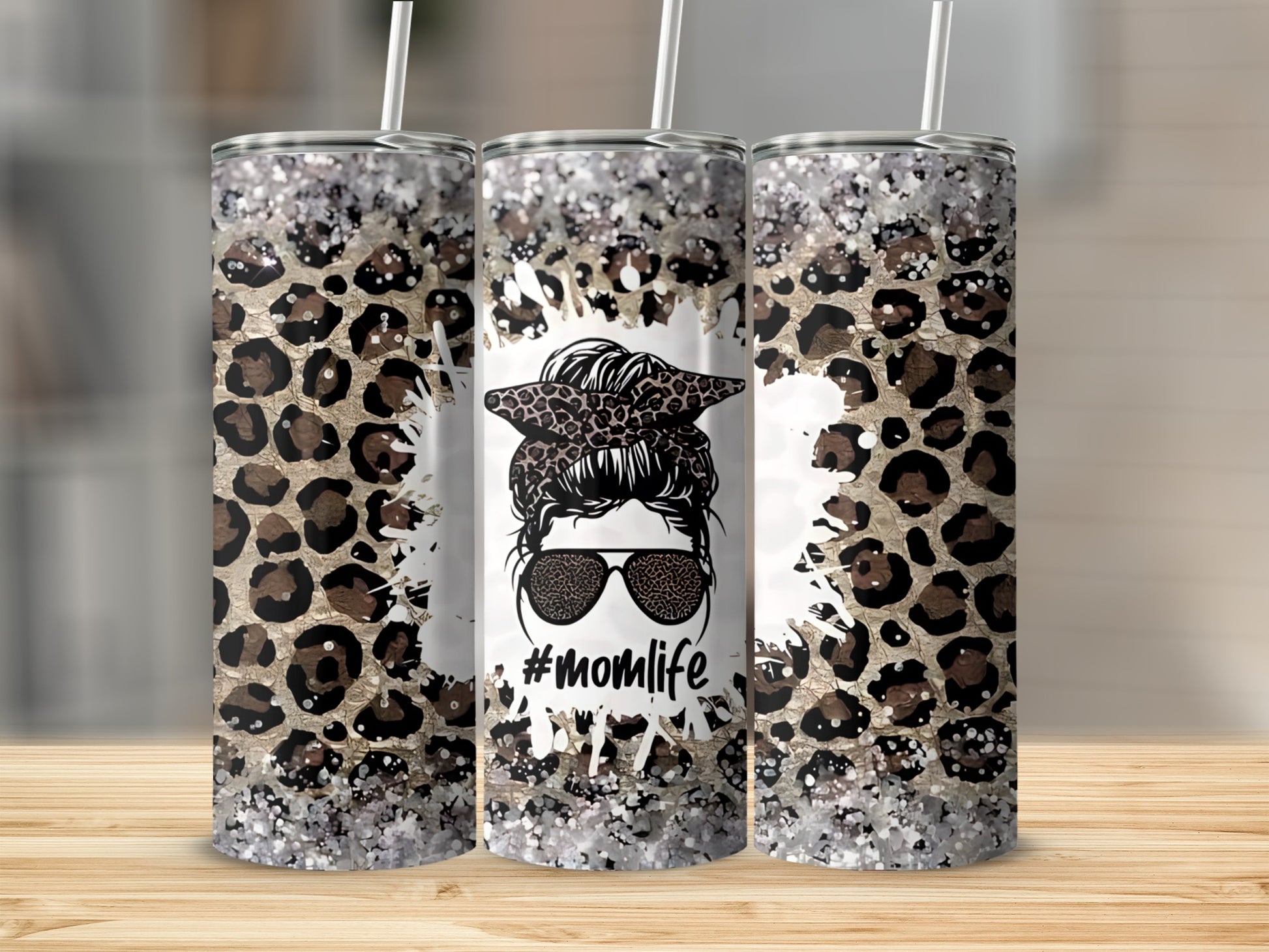 Leopard print tumbler with "Momlife" graphic and sunglasses.