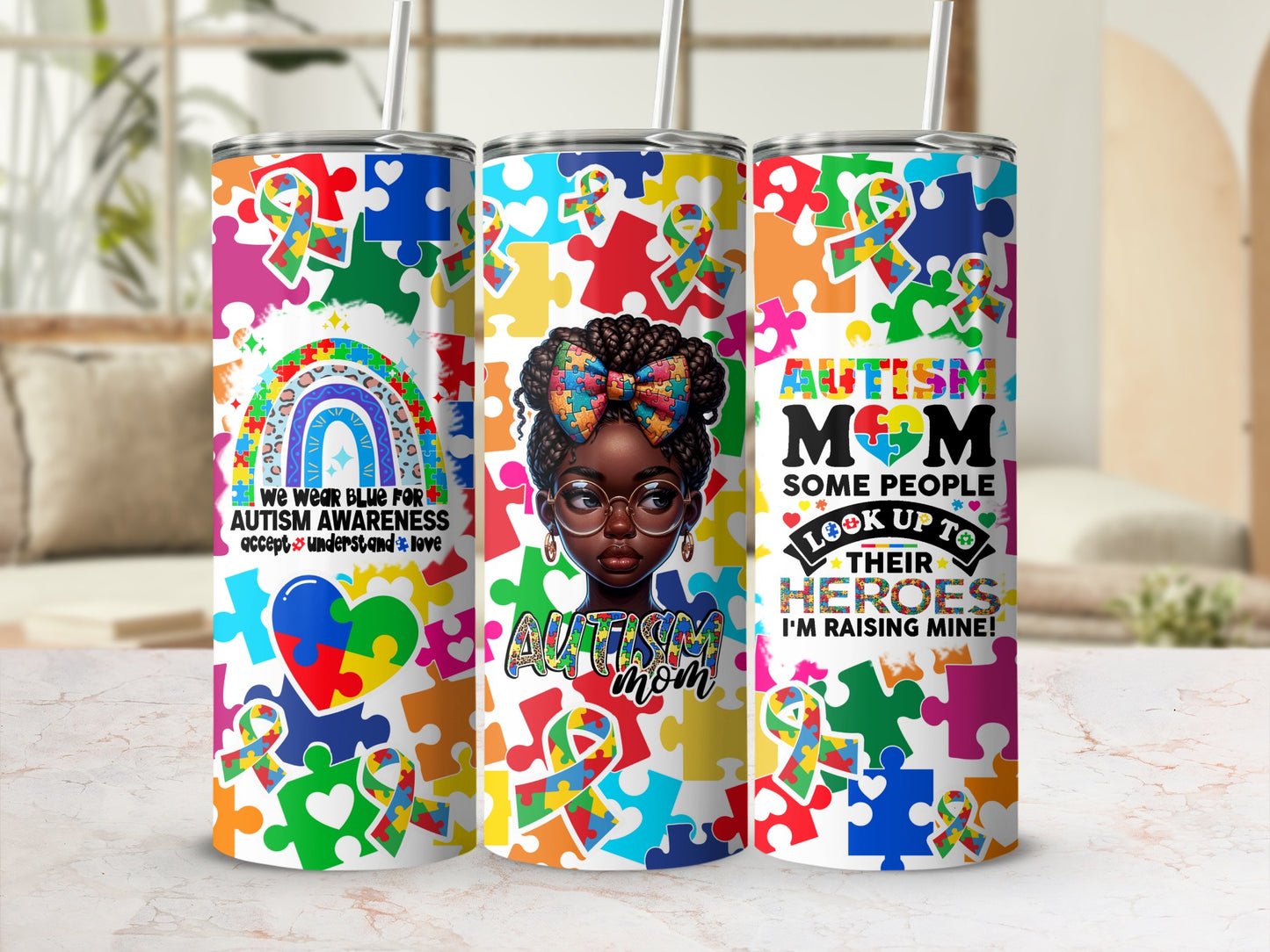 Colorful autism awareness tumblers with puzzle pieces and empowering text.