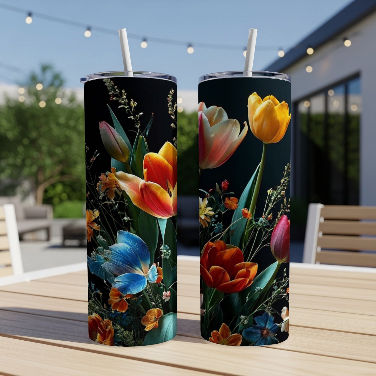 Two tumblers with a vibrant floral and butterfly design on a dark background.