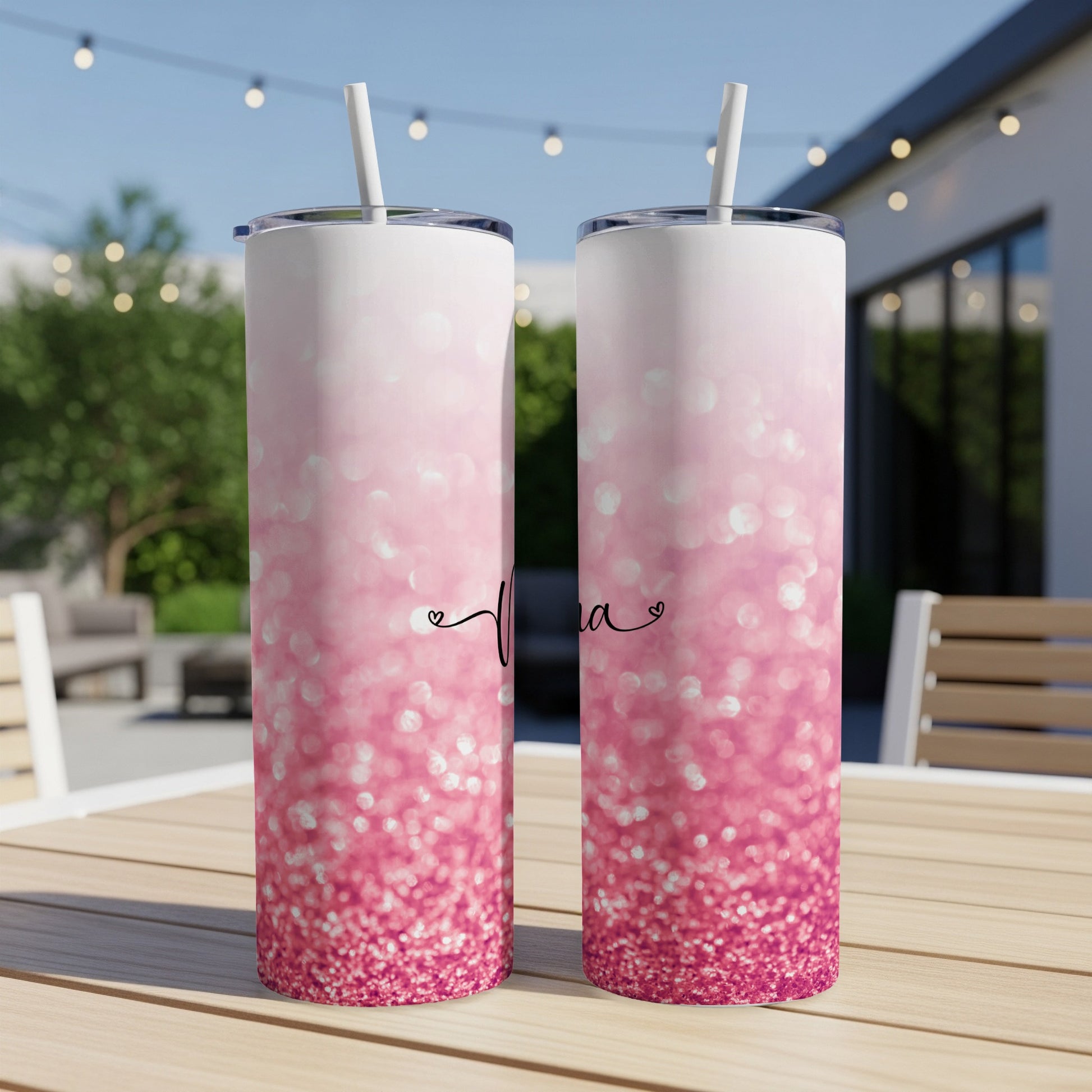 Two pink glitter tumblers with straws, personalized with "Mama" script.