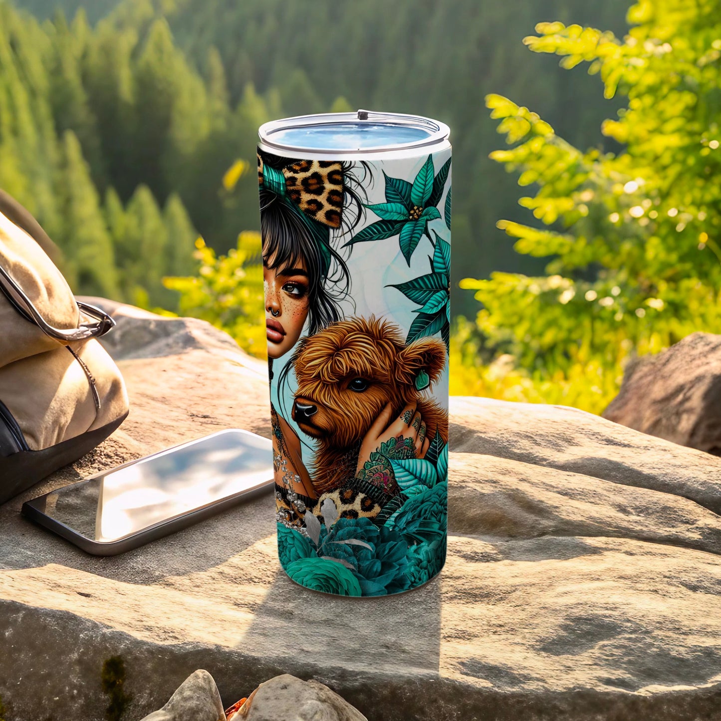 Tumbler with leopard print, cow, and floral design on outdoor surface.