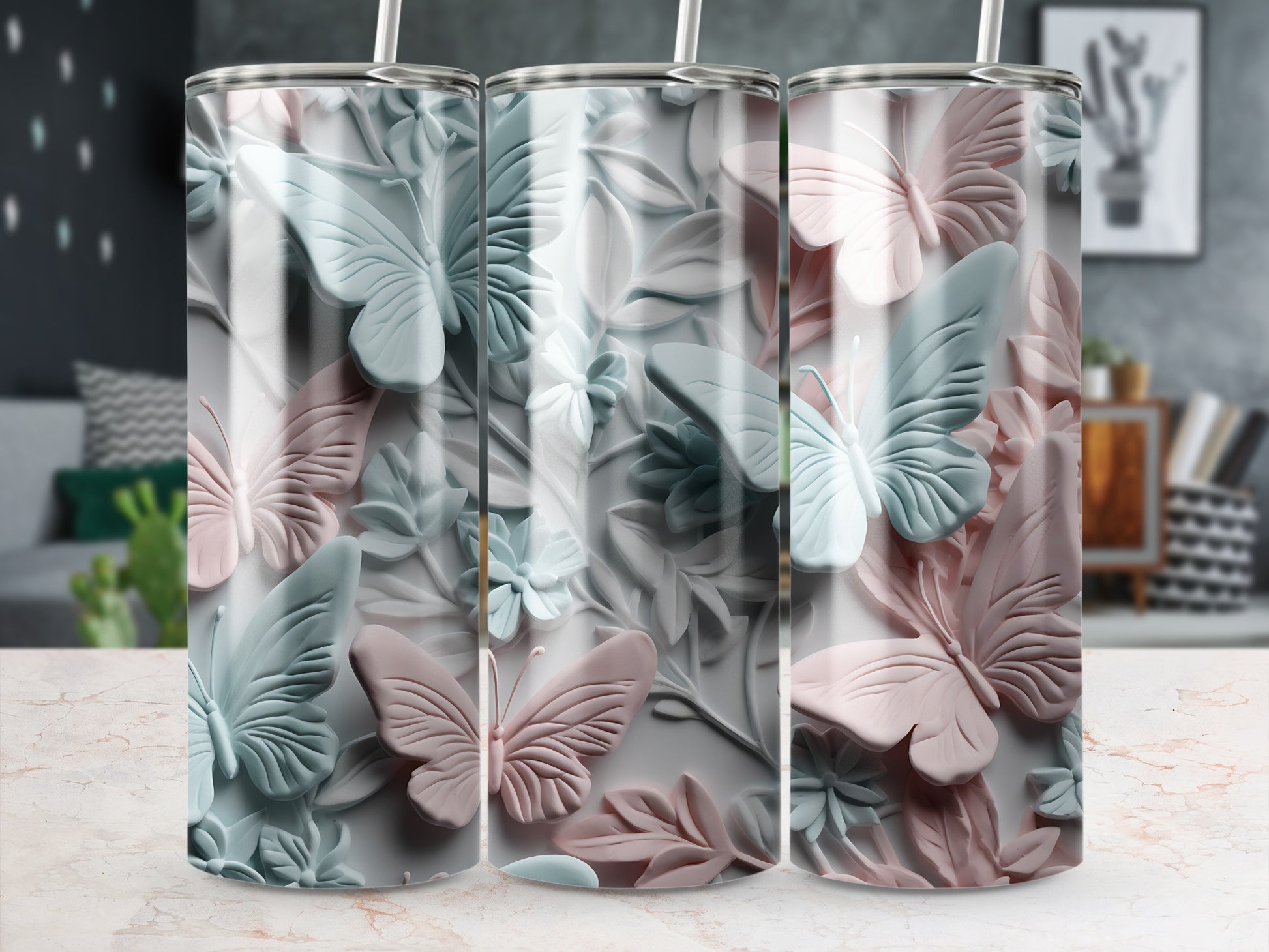 Three textured tumblers with embossed butterflies in pink and blue.