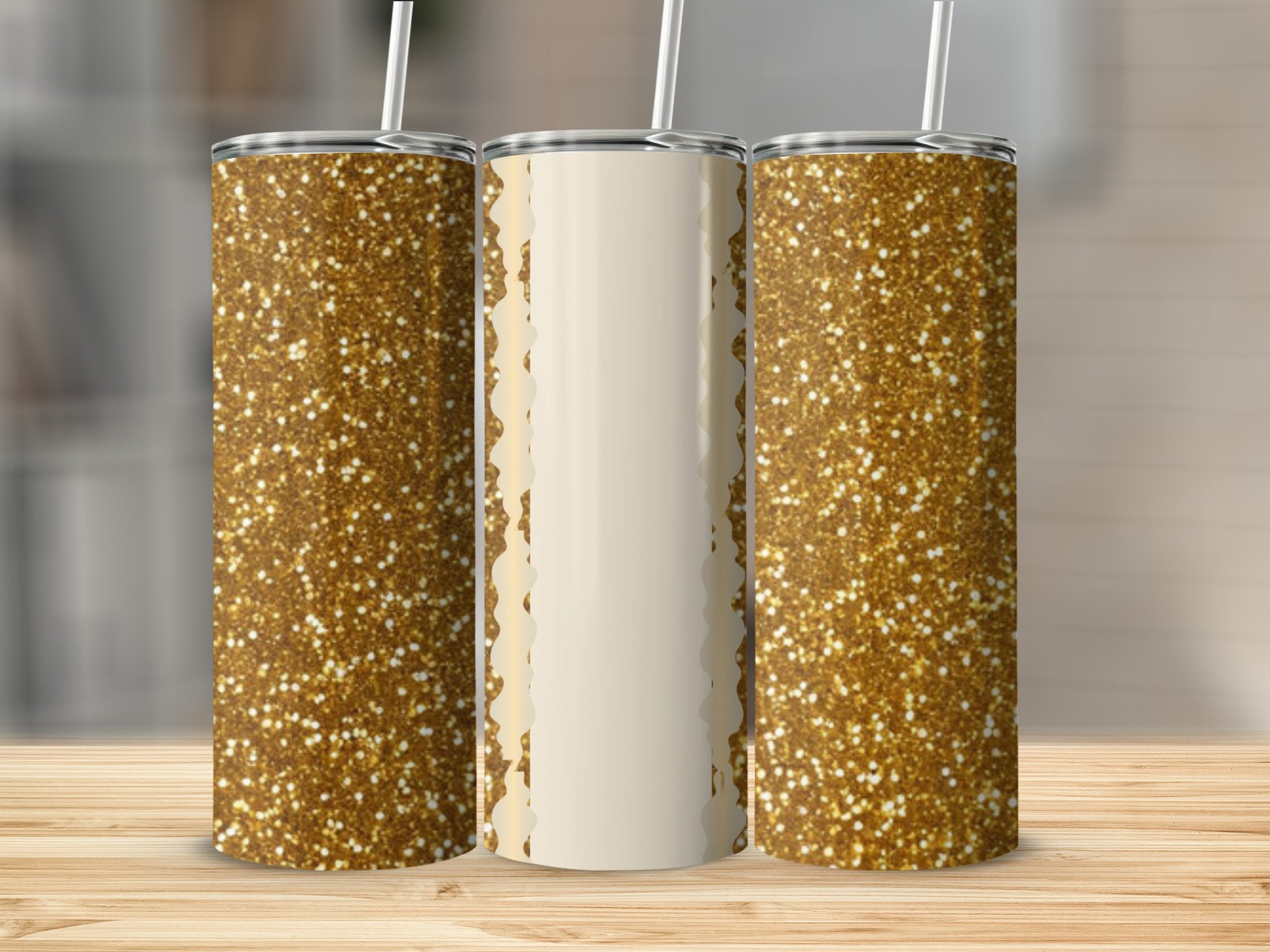 Three tumblers with gold glitter pattern and cream accents stand on a wooden surface.