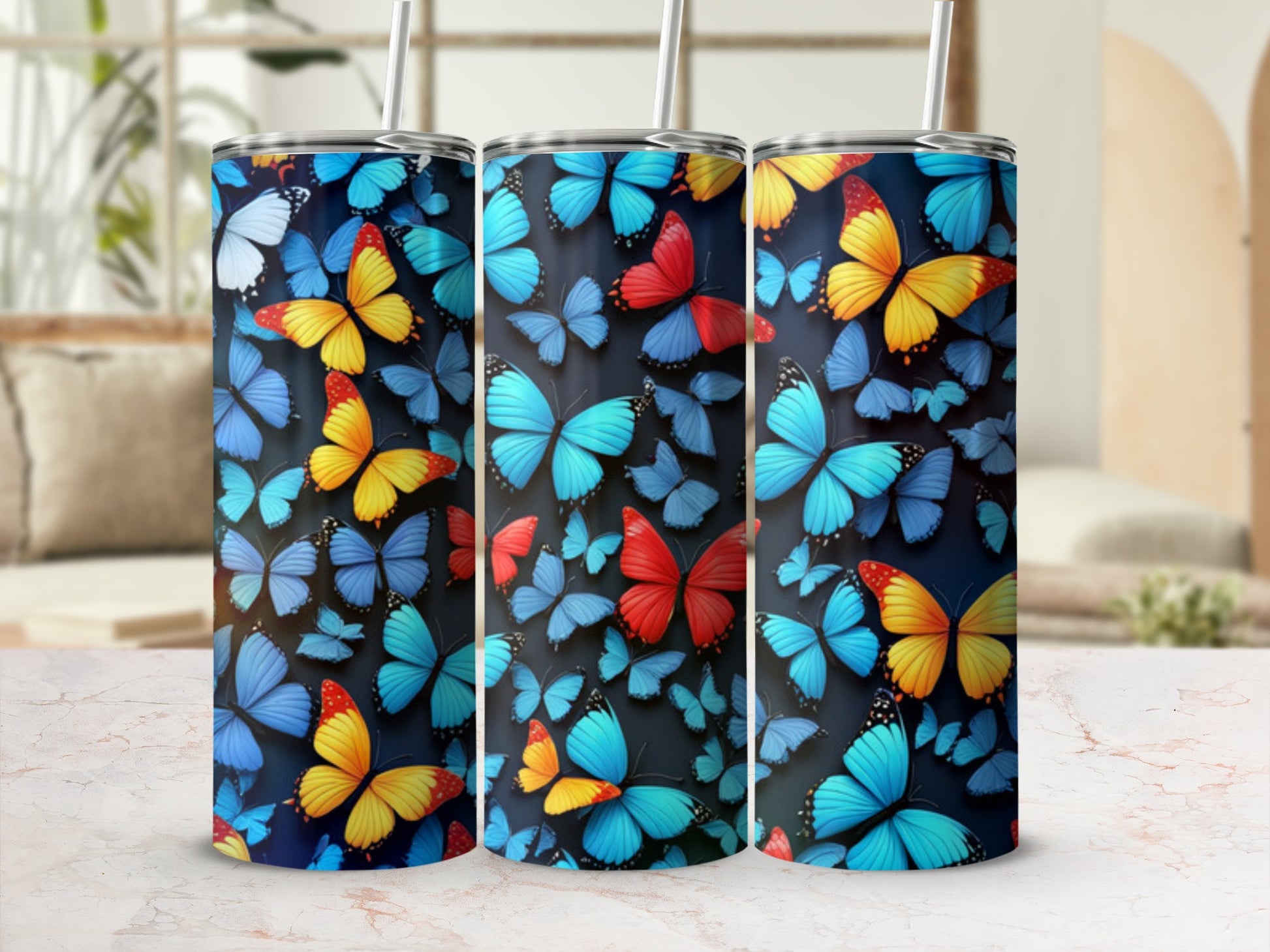 Three tumblers with a vibrant blue and yellow butterfly pattern.