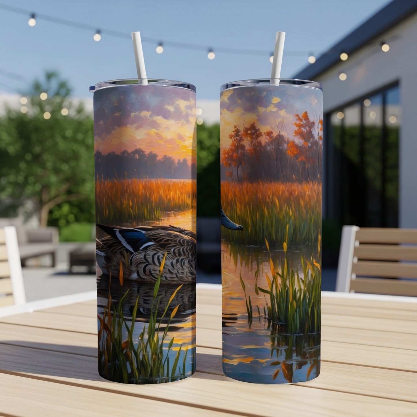 Two tumblers with a sunset over a marsh and a duck.