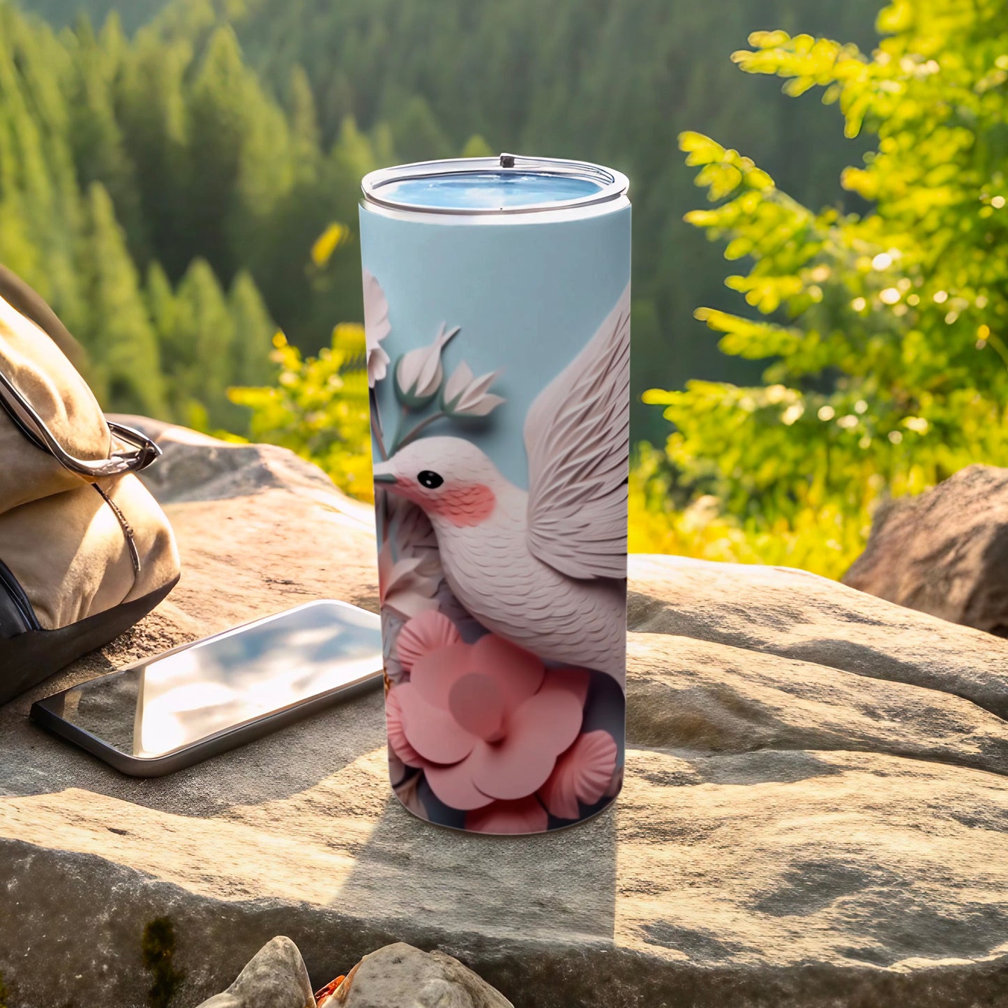 White bird and pink flowers on a blue background on a tumbler.
