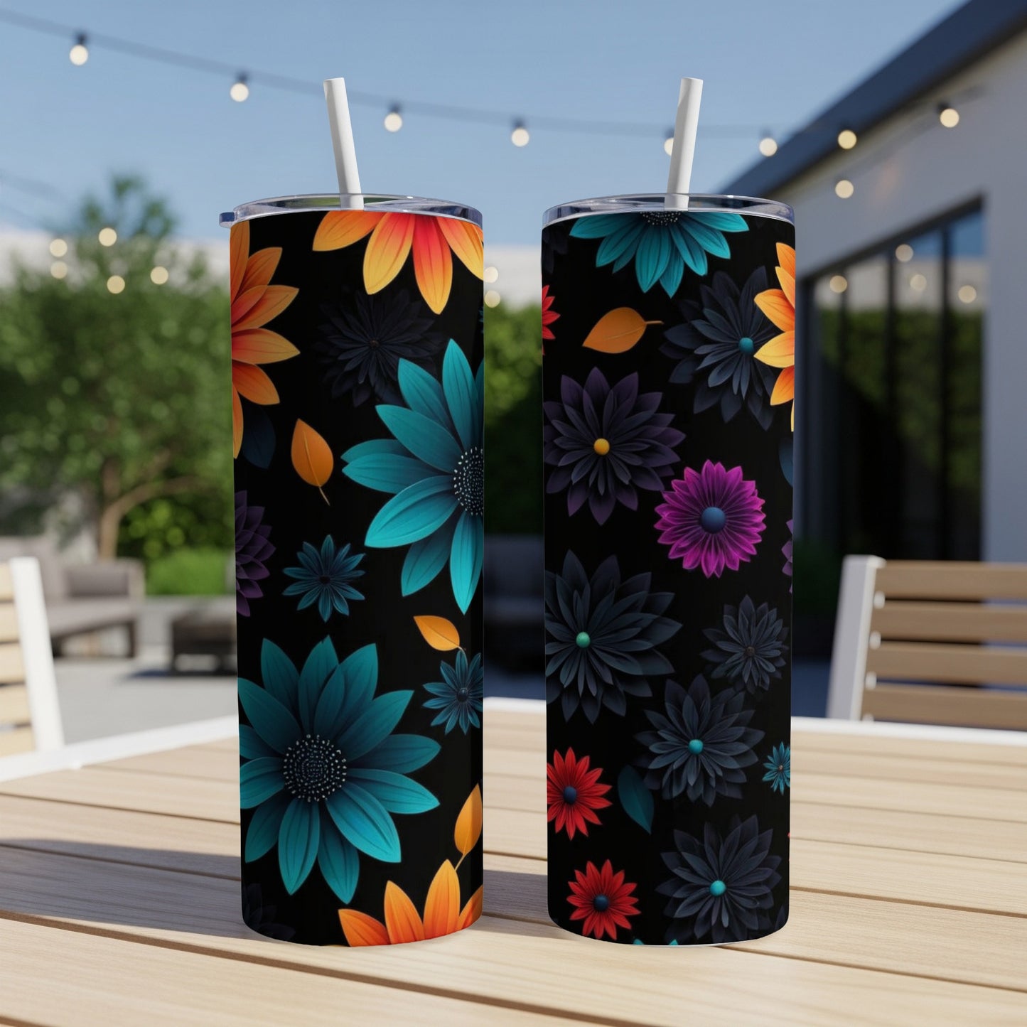 Two black tumblers with vibrant floral designs and straws.