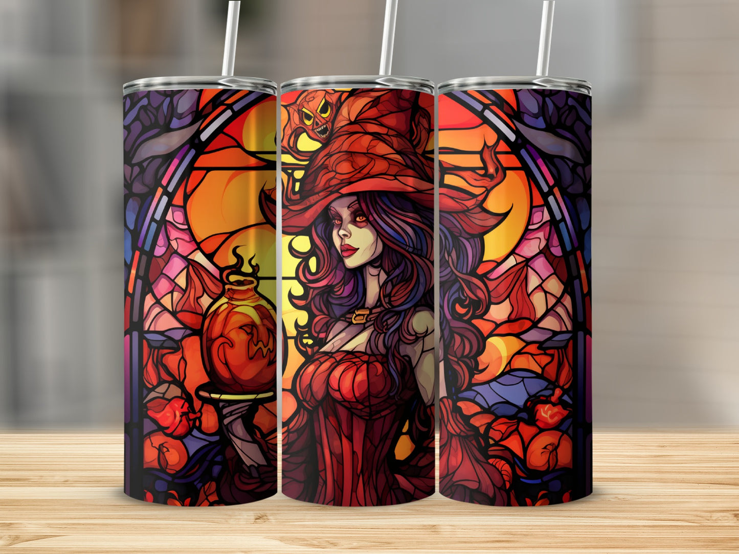 Three tumblers with stained-glass style Halloween witch art and pumpkins.