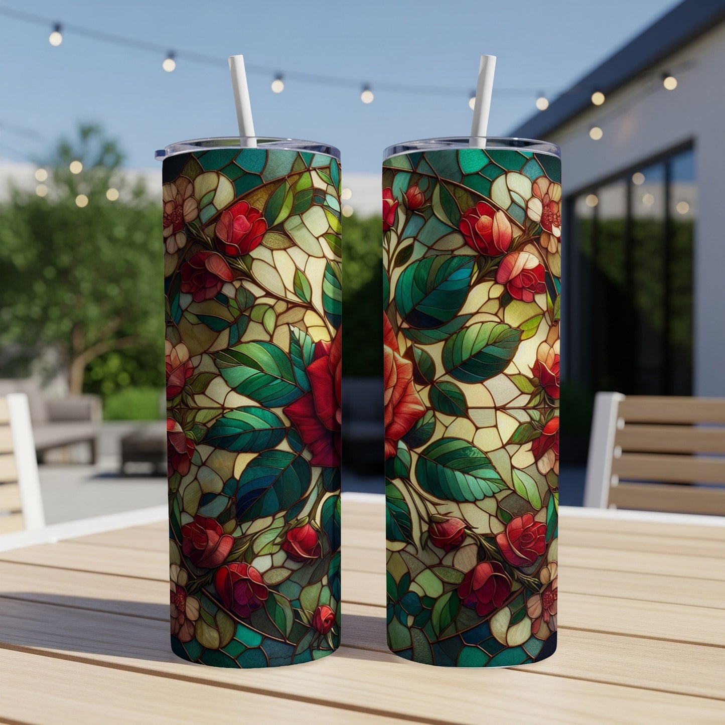 Two tumblers with stained glass floral pattern on an outdoor table.