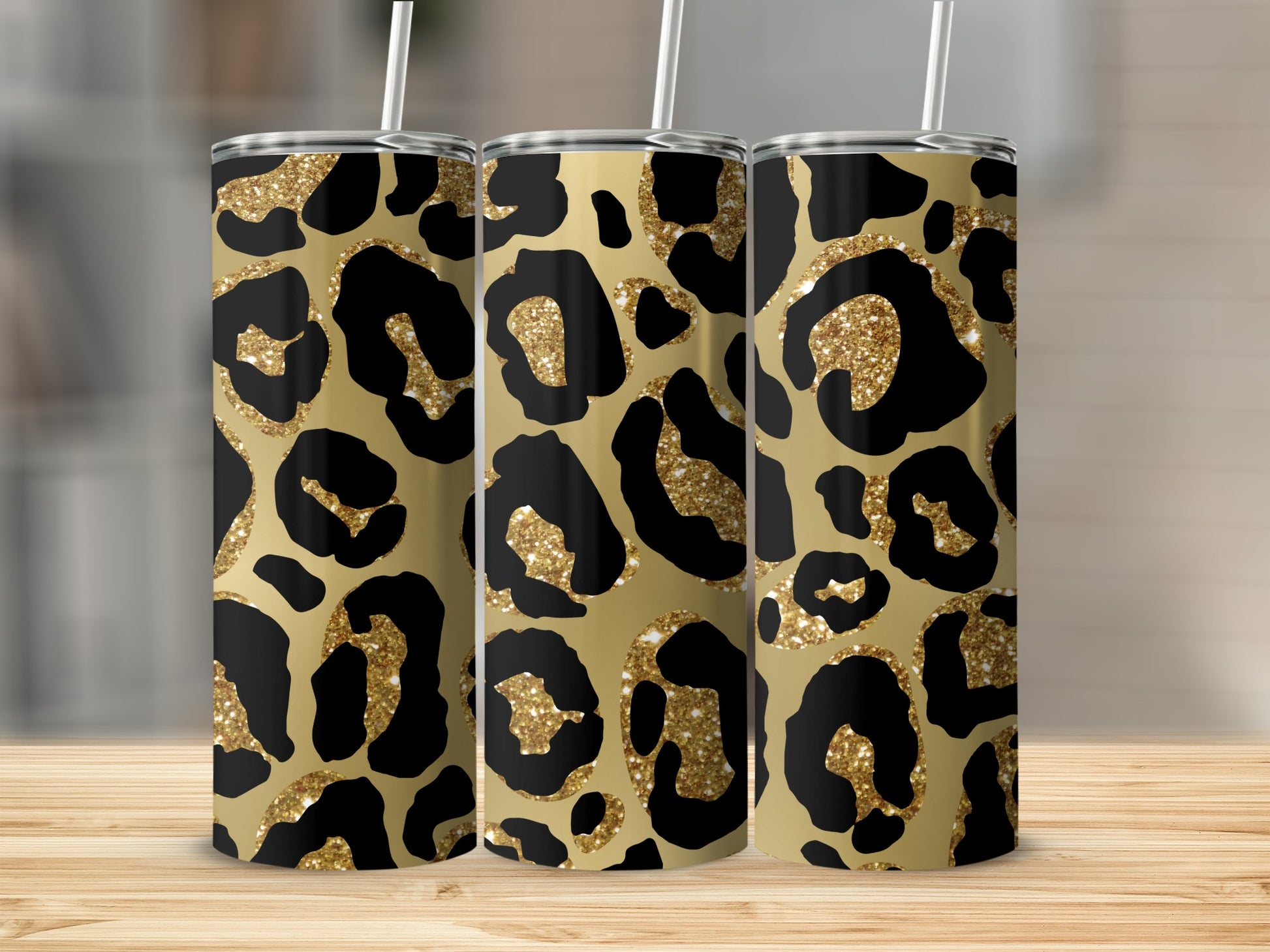 Three tumblers with gold glitter and black leopard print patterns.