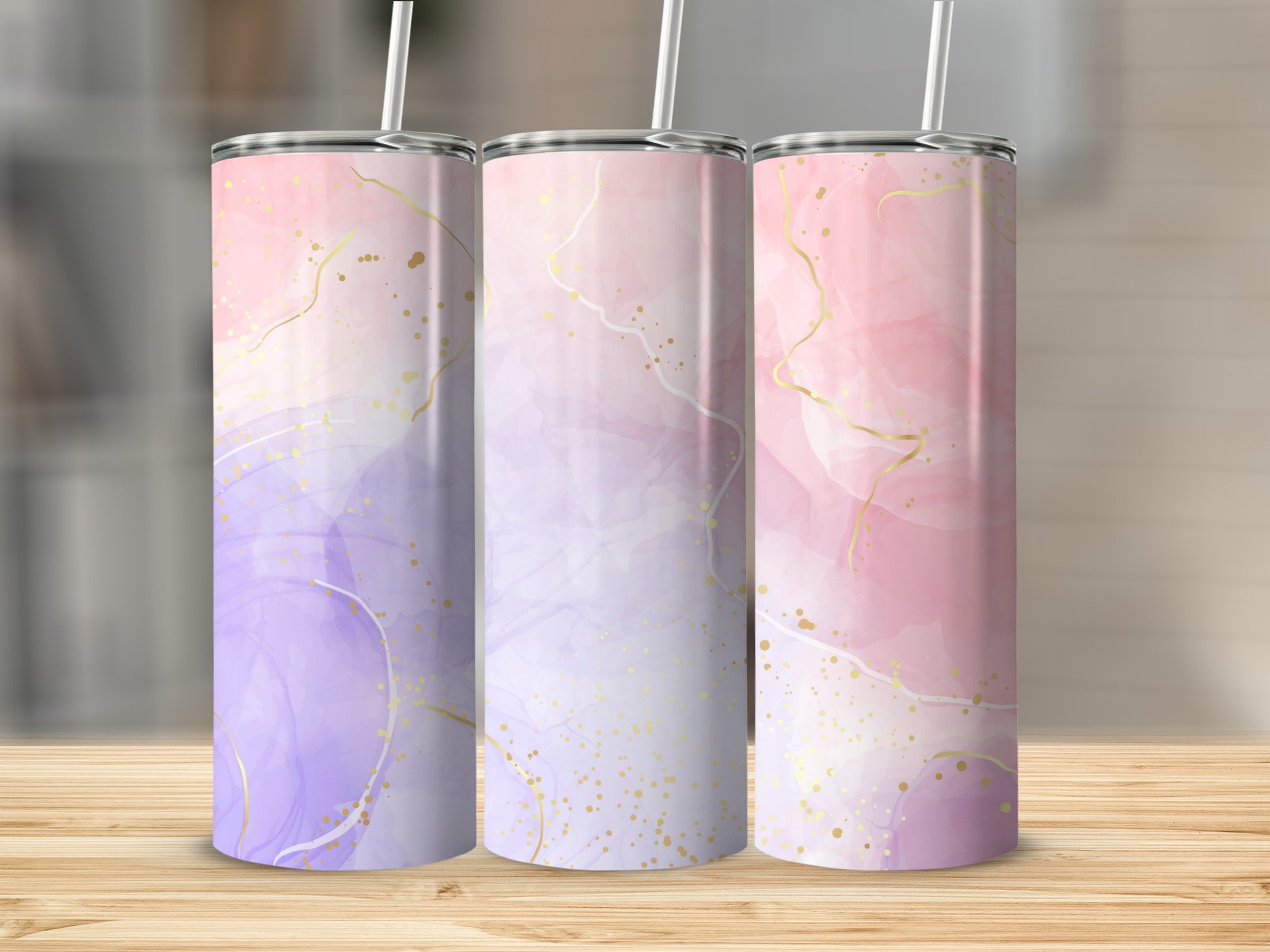 Three tumblers with purple and pink marble patterns and gold accents.