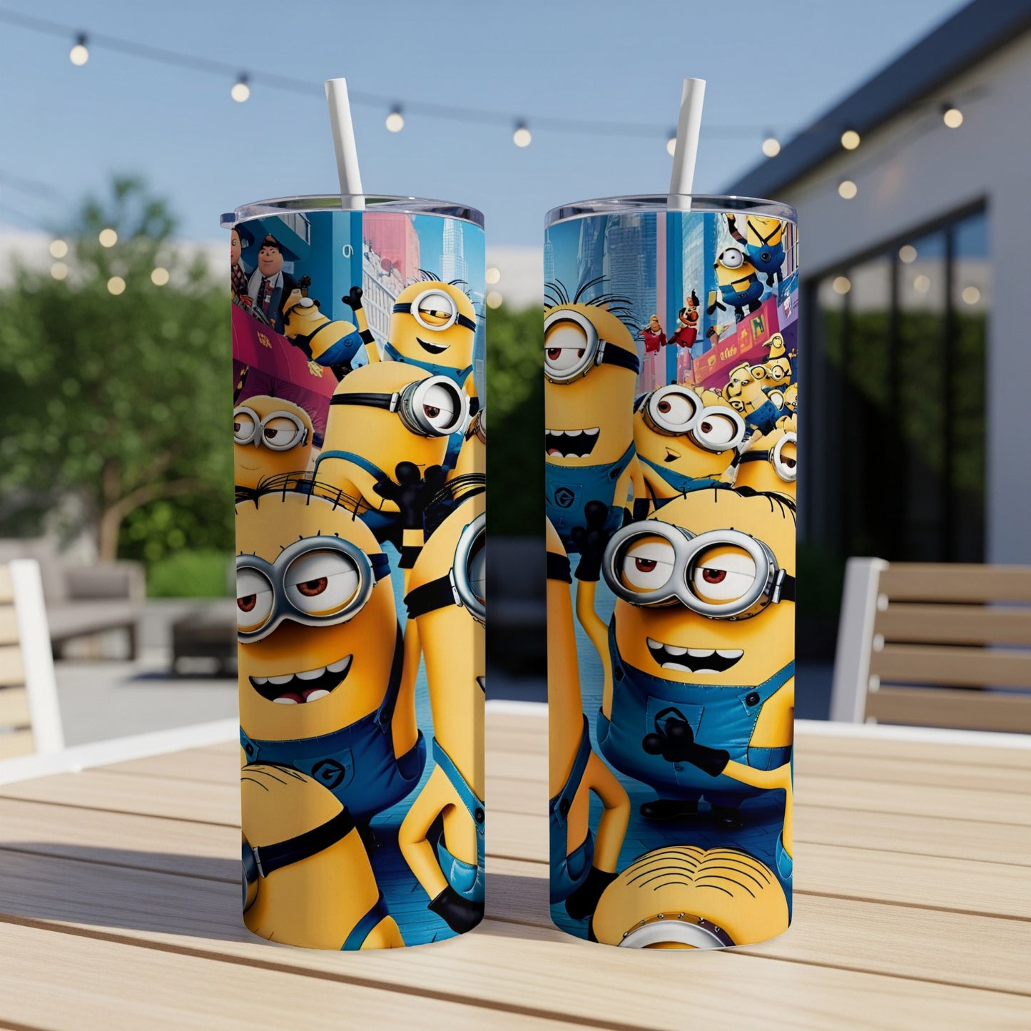 Minions characters on two tall tumblers with straws, set on a table.