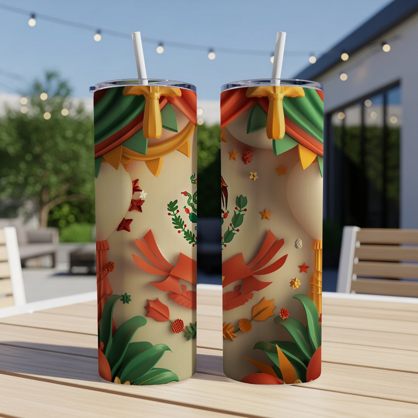 Two tumblers with Mexican flag and festive garland design sit on a table.