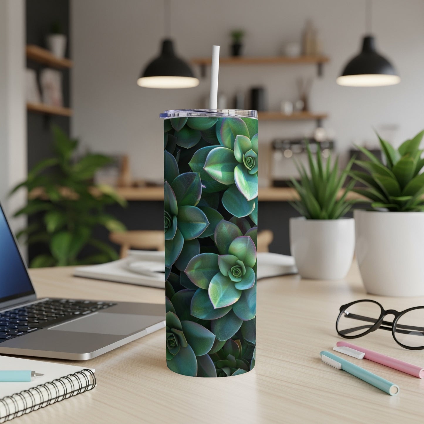 Green succulent plant pattern on a white tumbler with a straw.