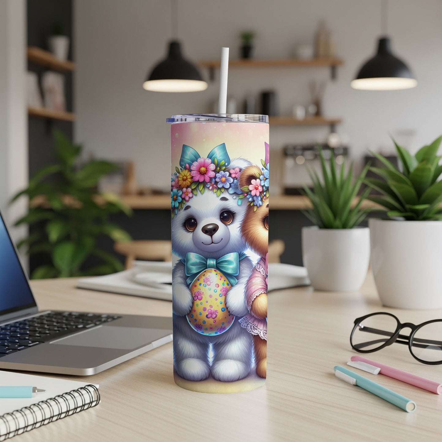 Two teddy bears in Easter outfits holding a decorated egg on a desk.