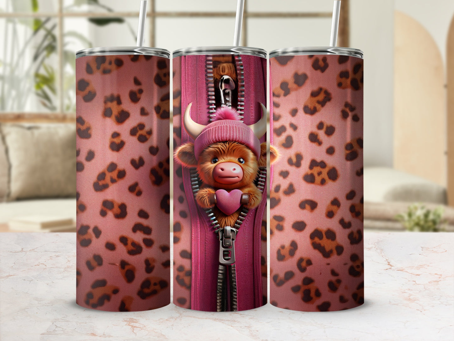 Pink leopard print tumbler with a zipped center showing a cartoon cow.