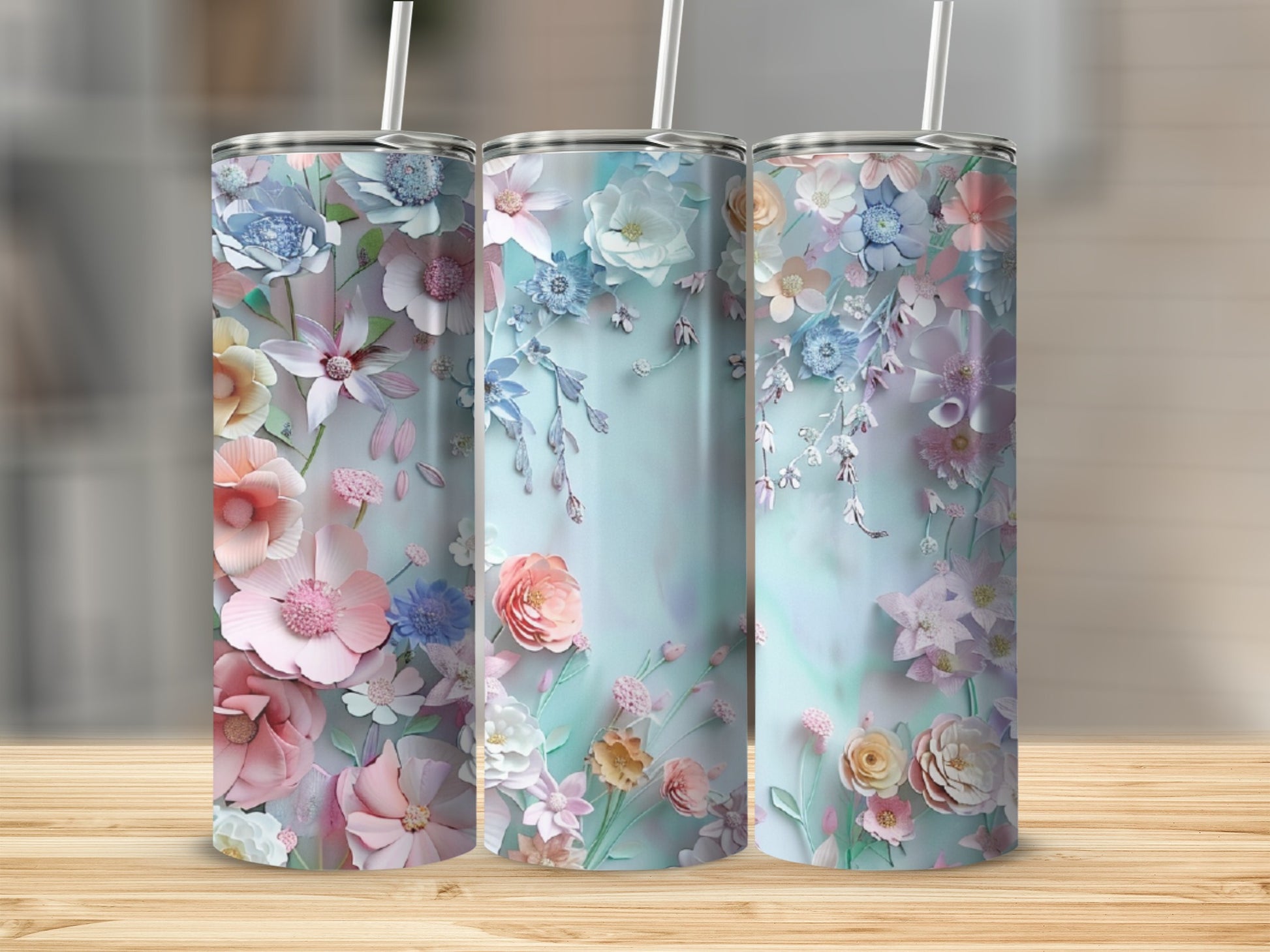 Three pastel tumblers featuring a delicate floral design.