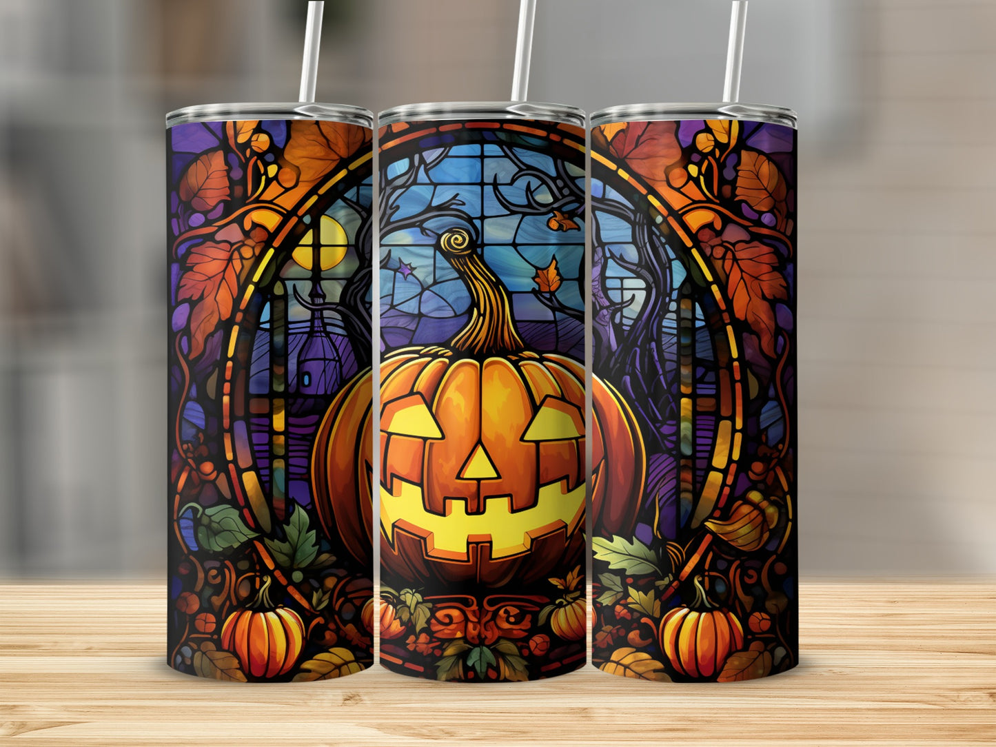 Stained glass pumpkin design on three tumblers with straws.