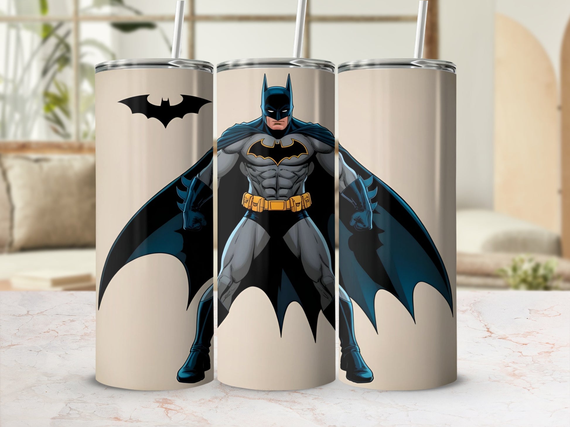 Batman logo and full-body illustration on three tan tumblers with straws.