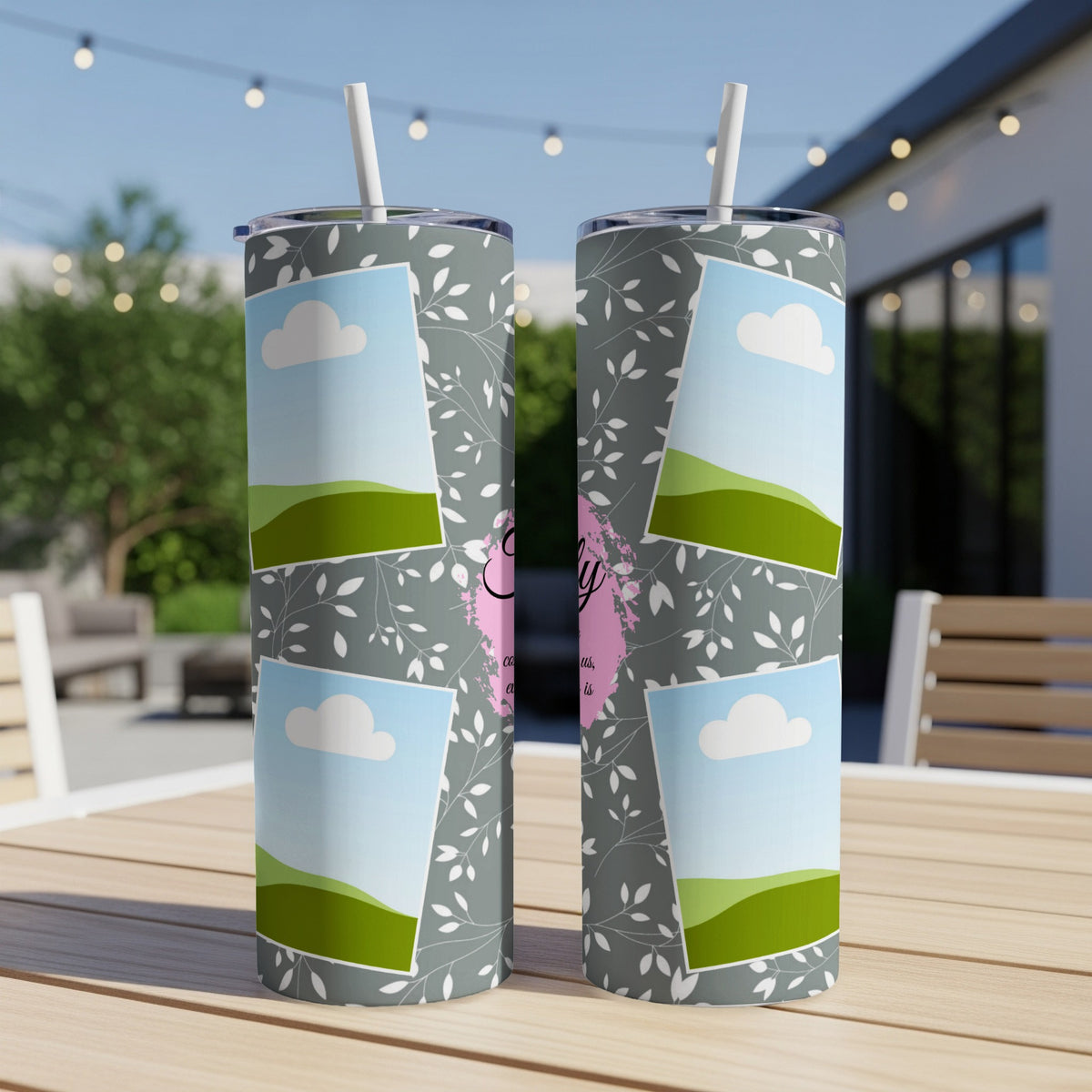 Two tumblers with floral pattern, clouds, and green hills with text.