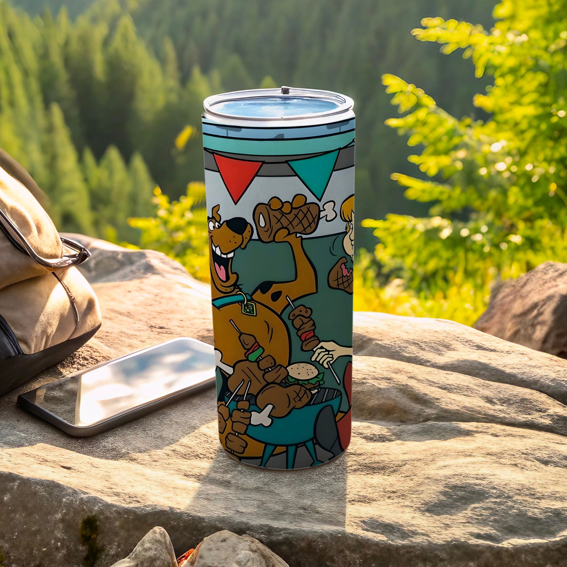Scooby-Doo on a picnic blanket with food, on a metal tumbler.