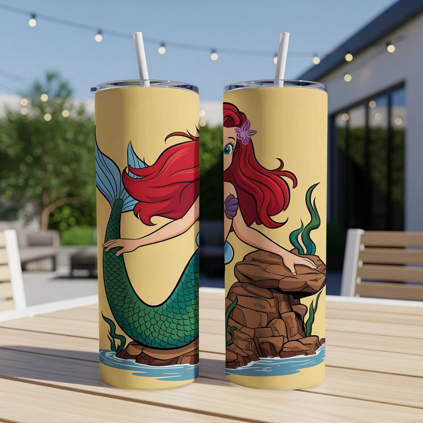 Ariel the mermaid on a yellow tumbler with a straw.