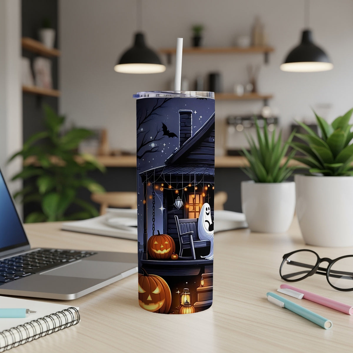 Tall tumbler with Halloween haunted house, pumpkins, and ghost design.