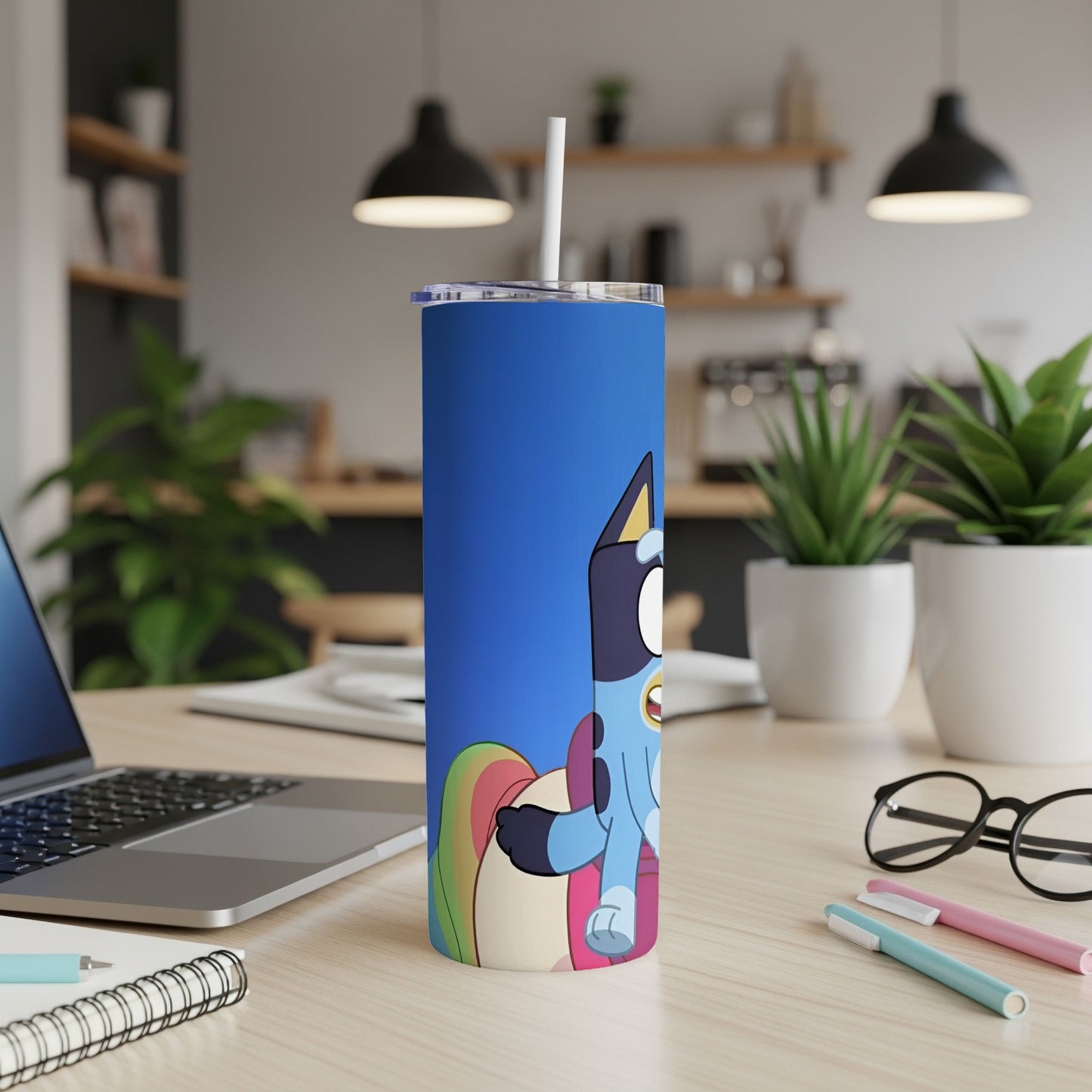 Bluey and Bingo cartoon characters on a blue tumbler with a straw.
