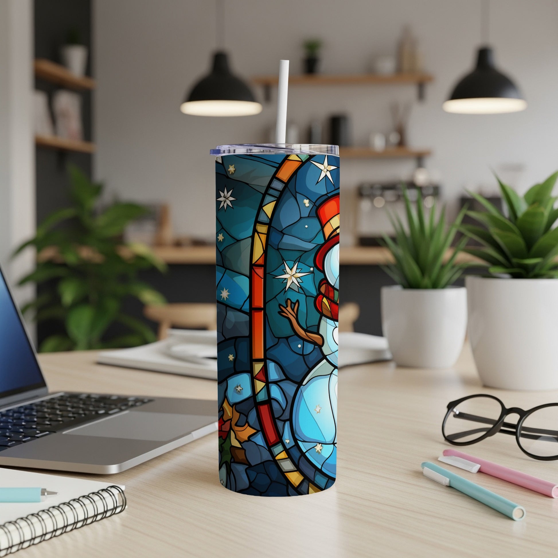 Stained glass snowman design on a white skinny tumbler with straw.