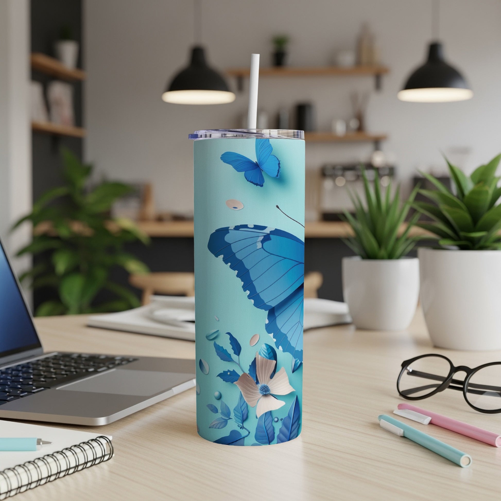 Light blue tumbler with blue butterfly and floral design.