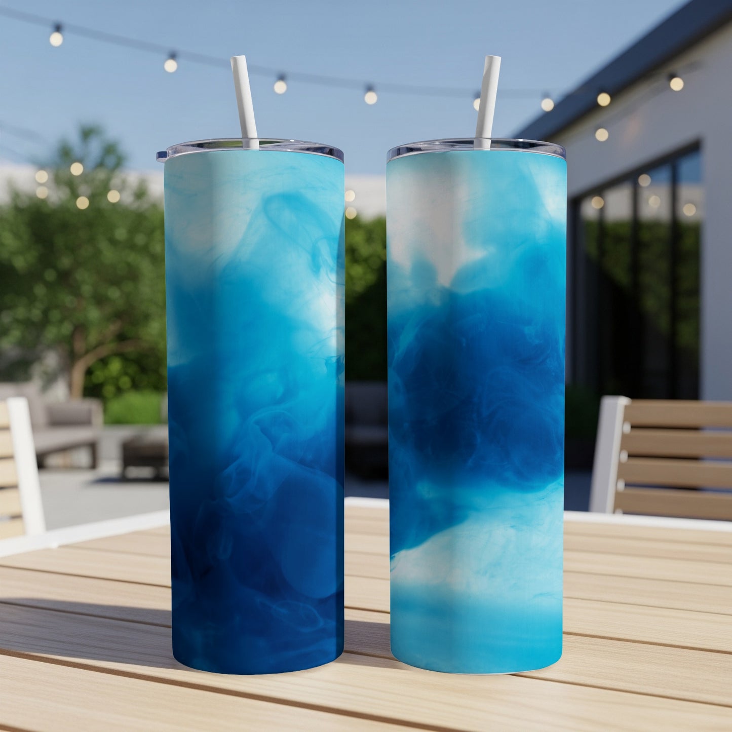 Two tumblers with blue and white smoke design on a wooden table.