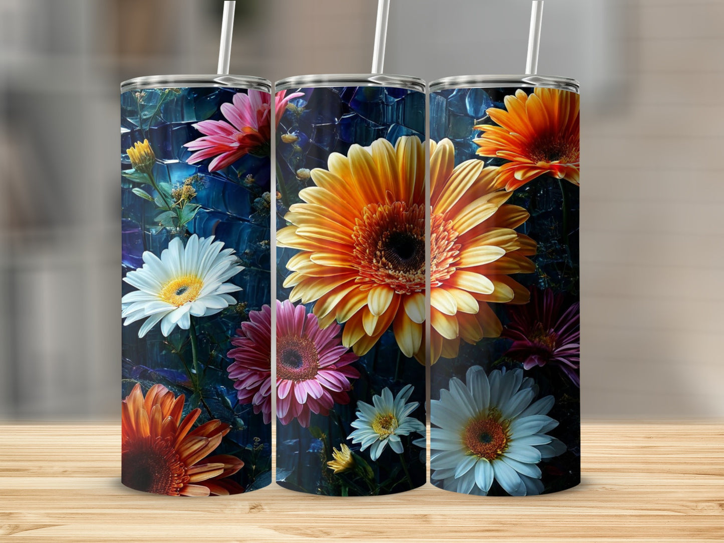 Three tumblers featuring vibrant, colorful floral patterns on a dark background.