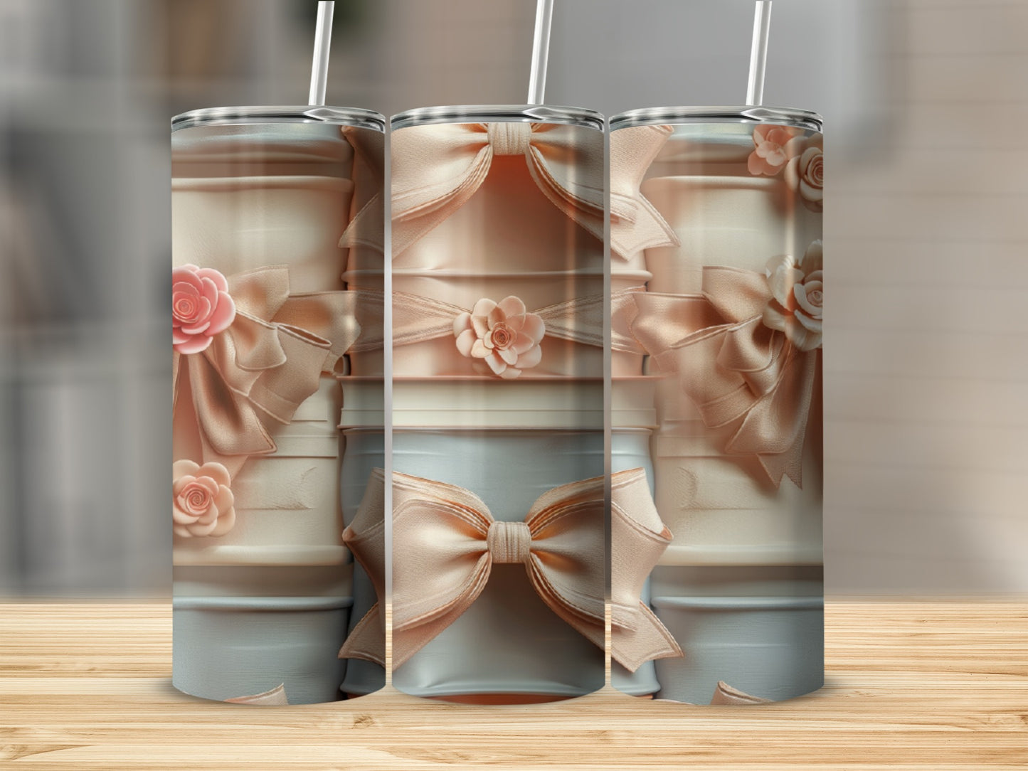 Three blush pink tumblers decorated with satin bows and floral accents.