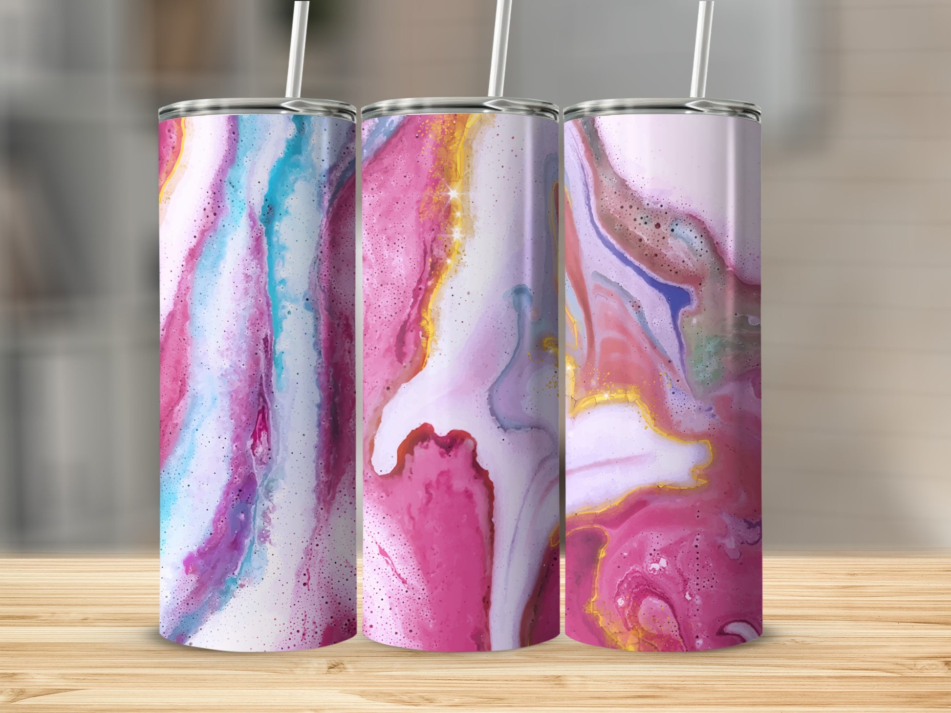 Three tumblers with marbled pink, blue, and purple abstract designs on a wooden surface.