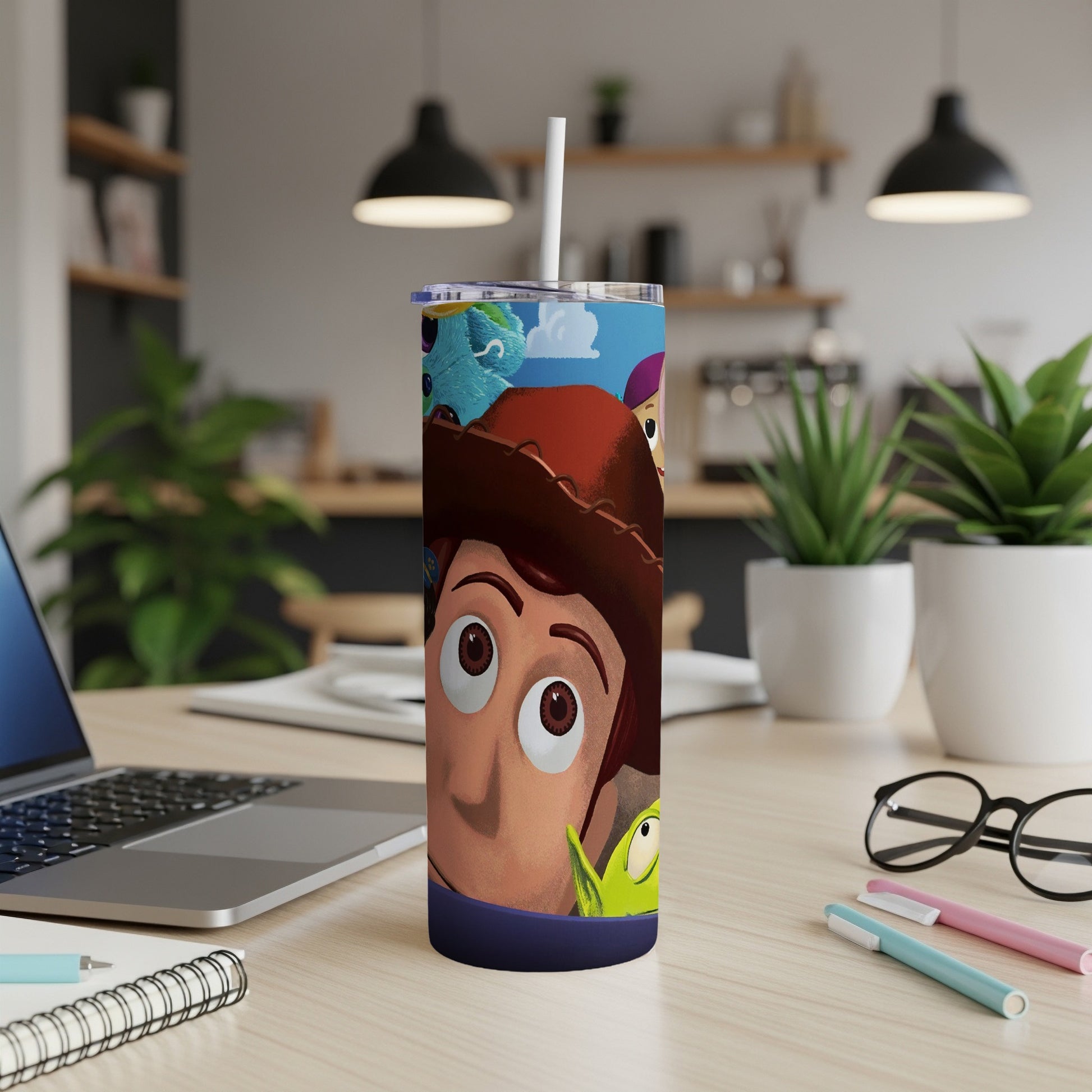 Woody and alien from Toy Story on a blue tumbler with straw.