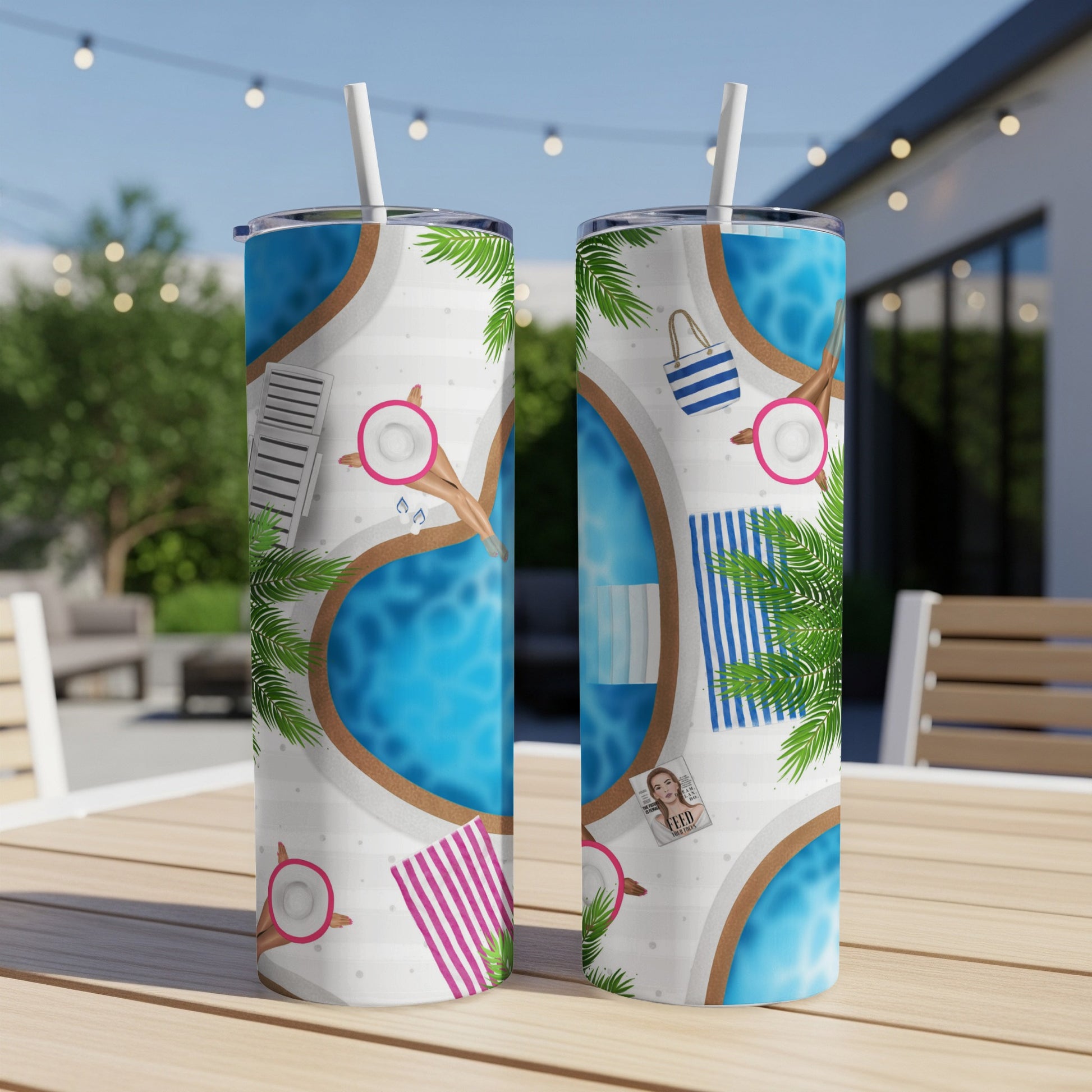 Two tumblers with tropical pool scene and palm trees on table.