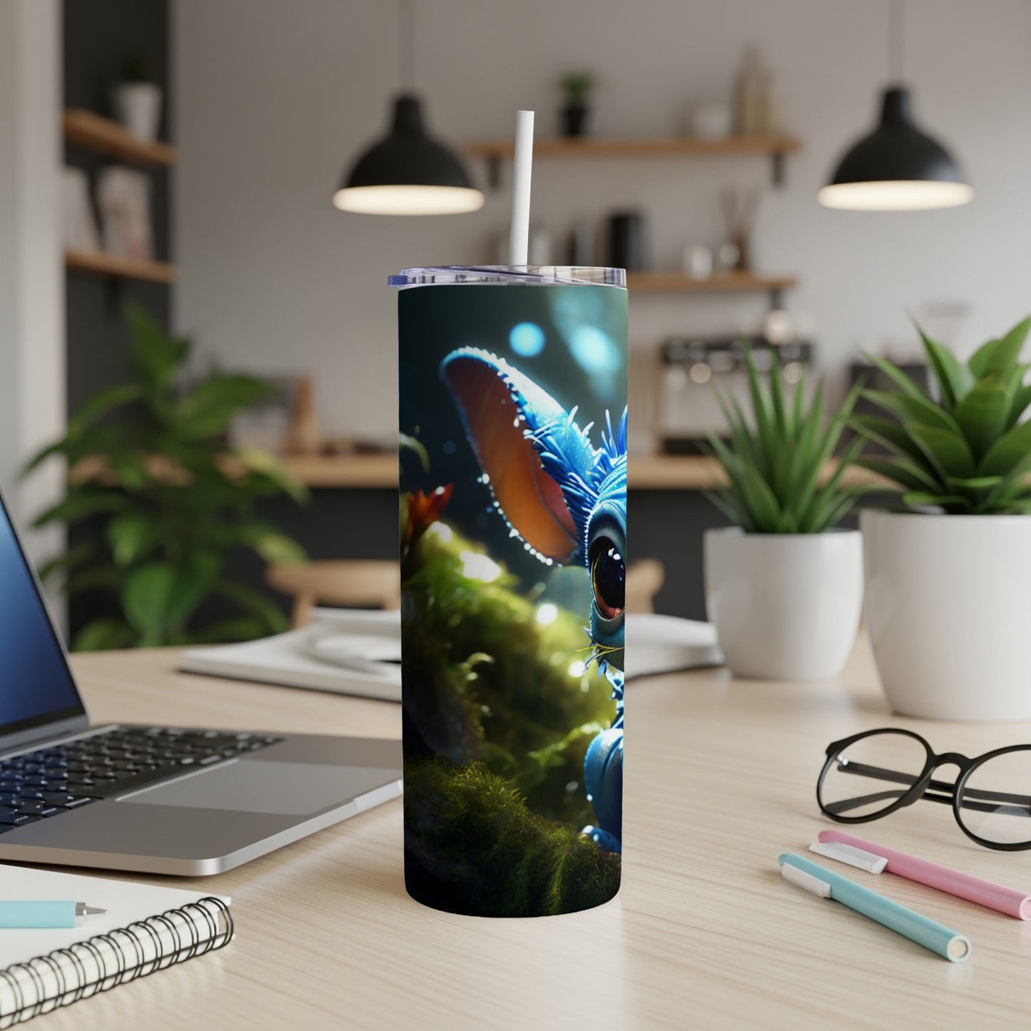 Blue alien character on a nature-themed tumbler with a straw.