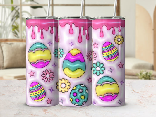 Three pastel Easter egg tumblers with floral accents and pink dripping designs.