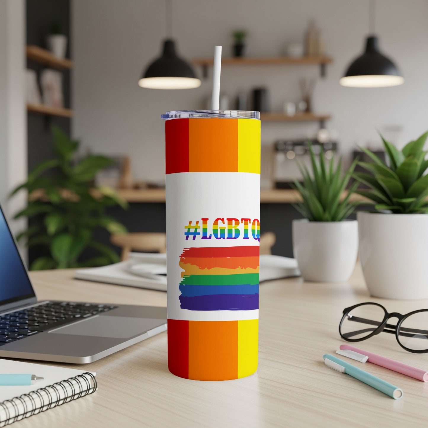 Rainbow striped tumbler with "#LGBTQ" hashtag on white label.