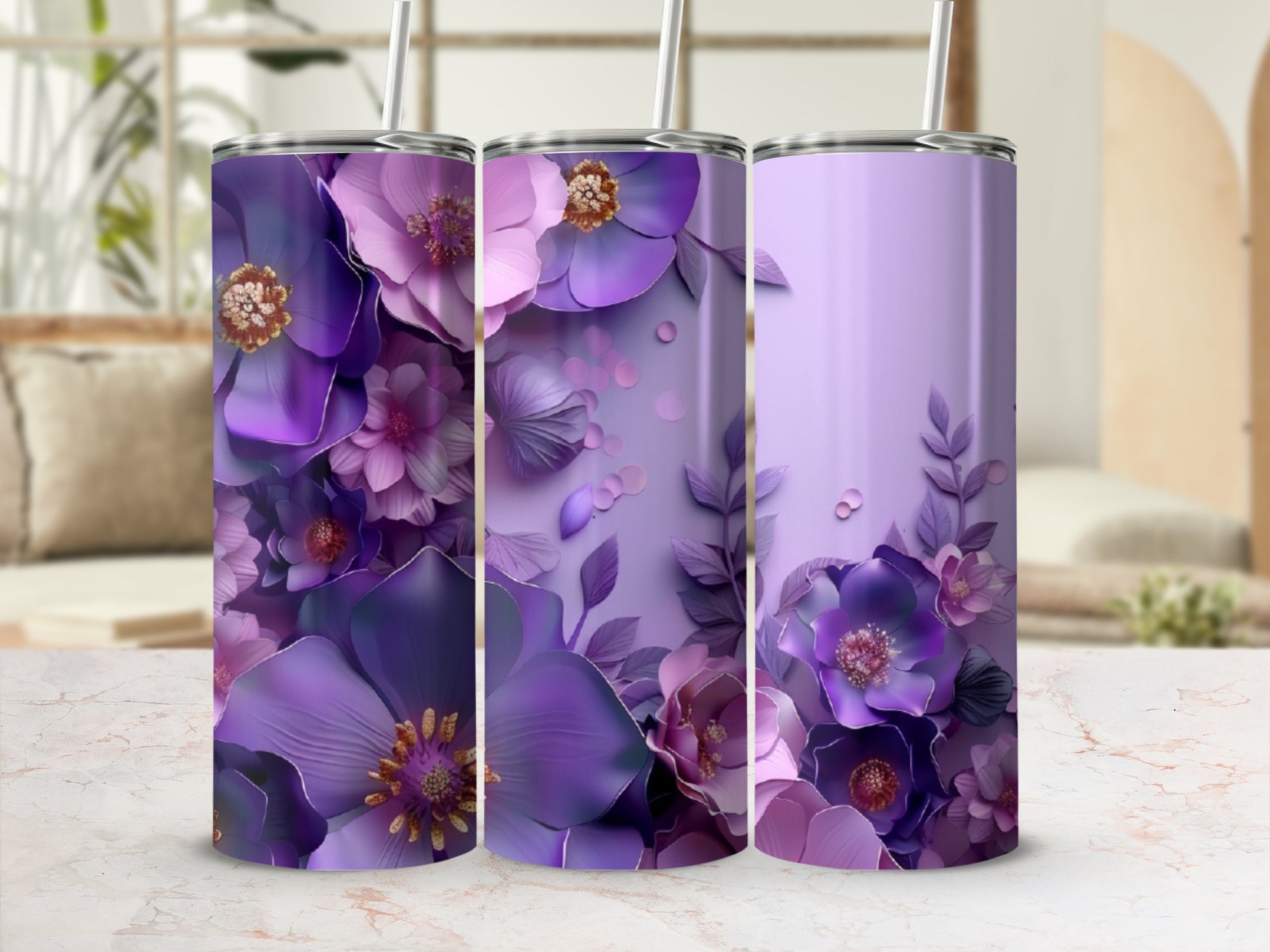 Purple floral patterned tumblers with straws on a marble countertop.