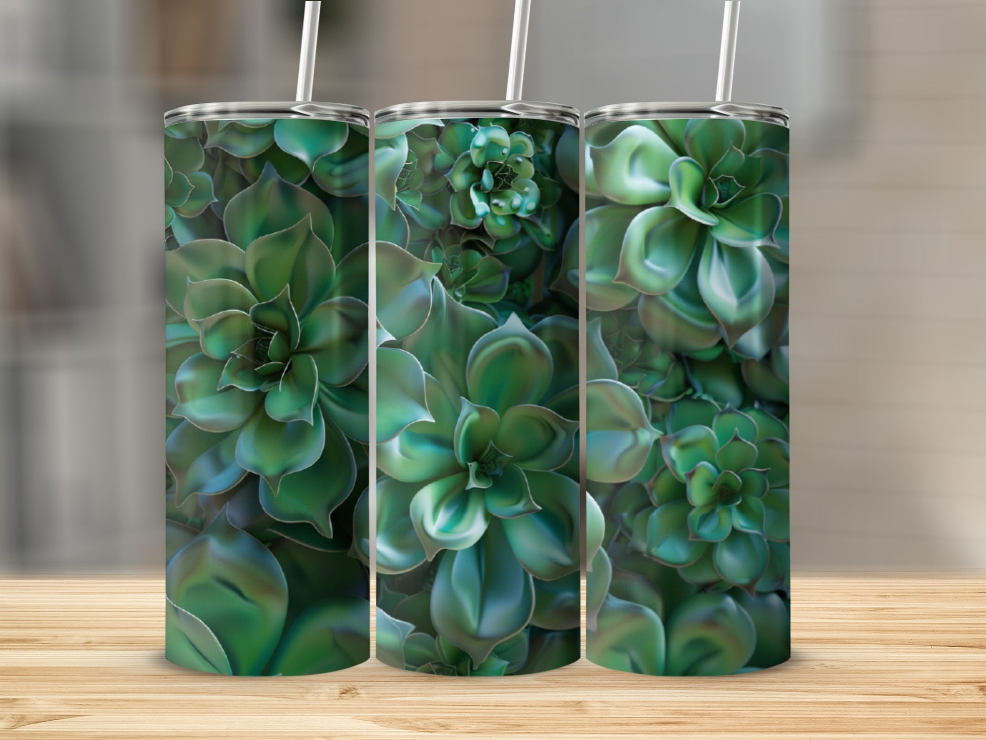 Three tumblers with a close-up succulent plant pattern on a wooden surface.