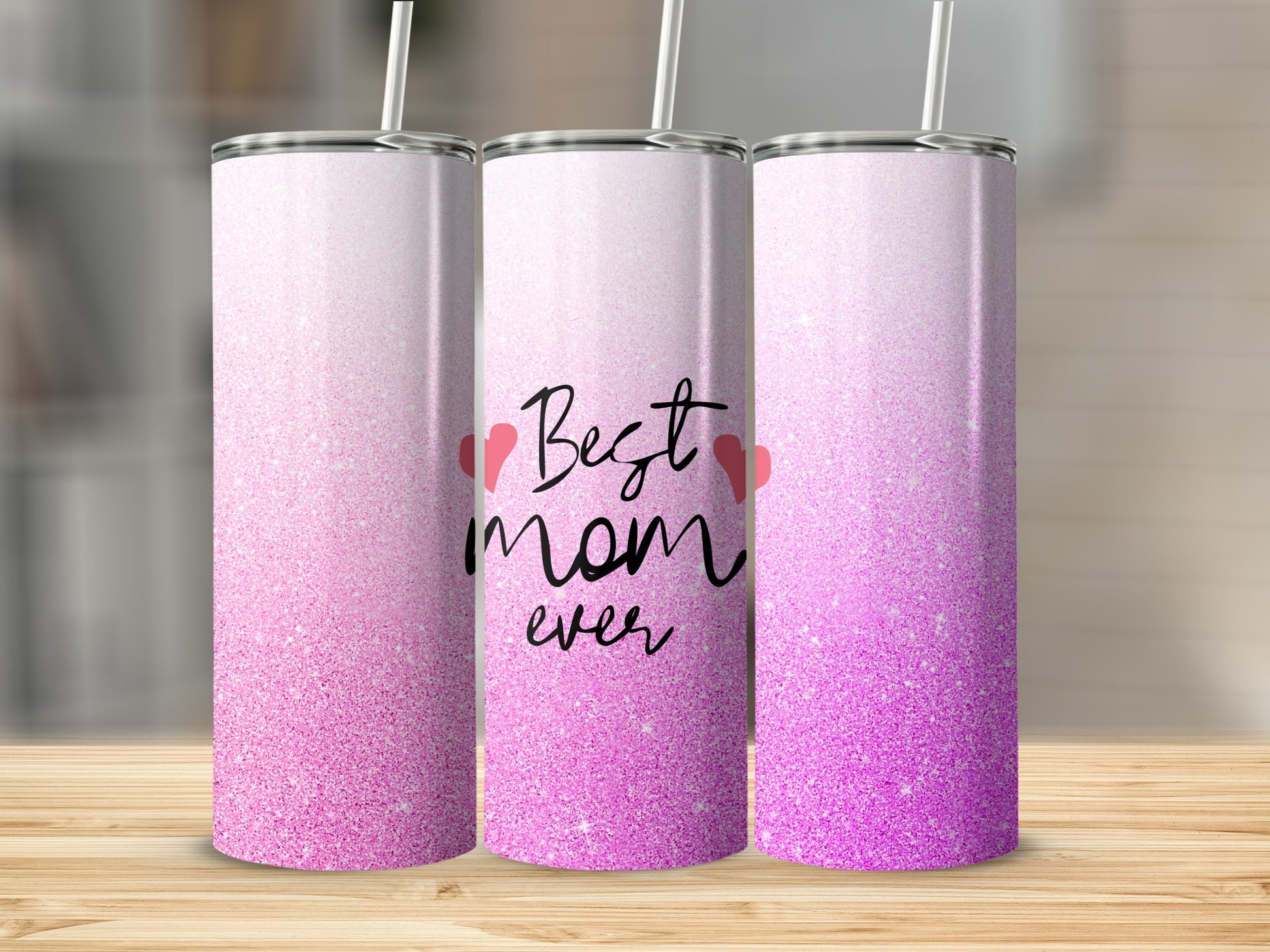 Pink glitter tumbler with "Best Mom Ever" text and straw.