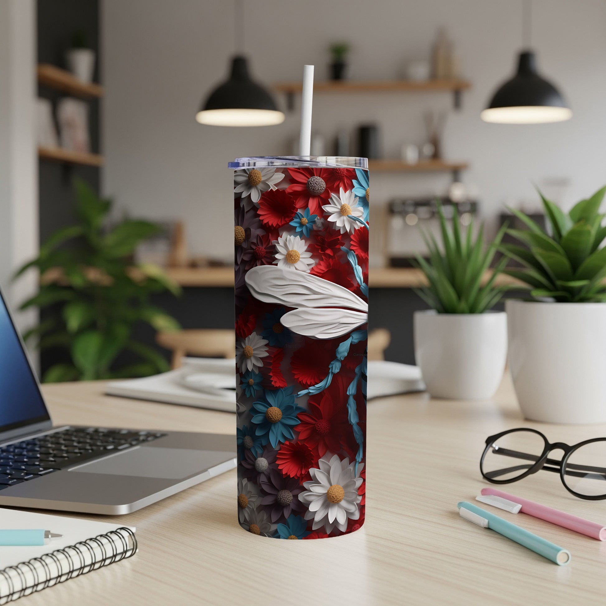 Red tumbler with floral pattern and dragonfly illustration.