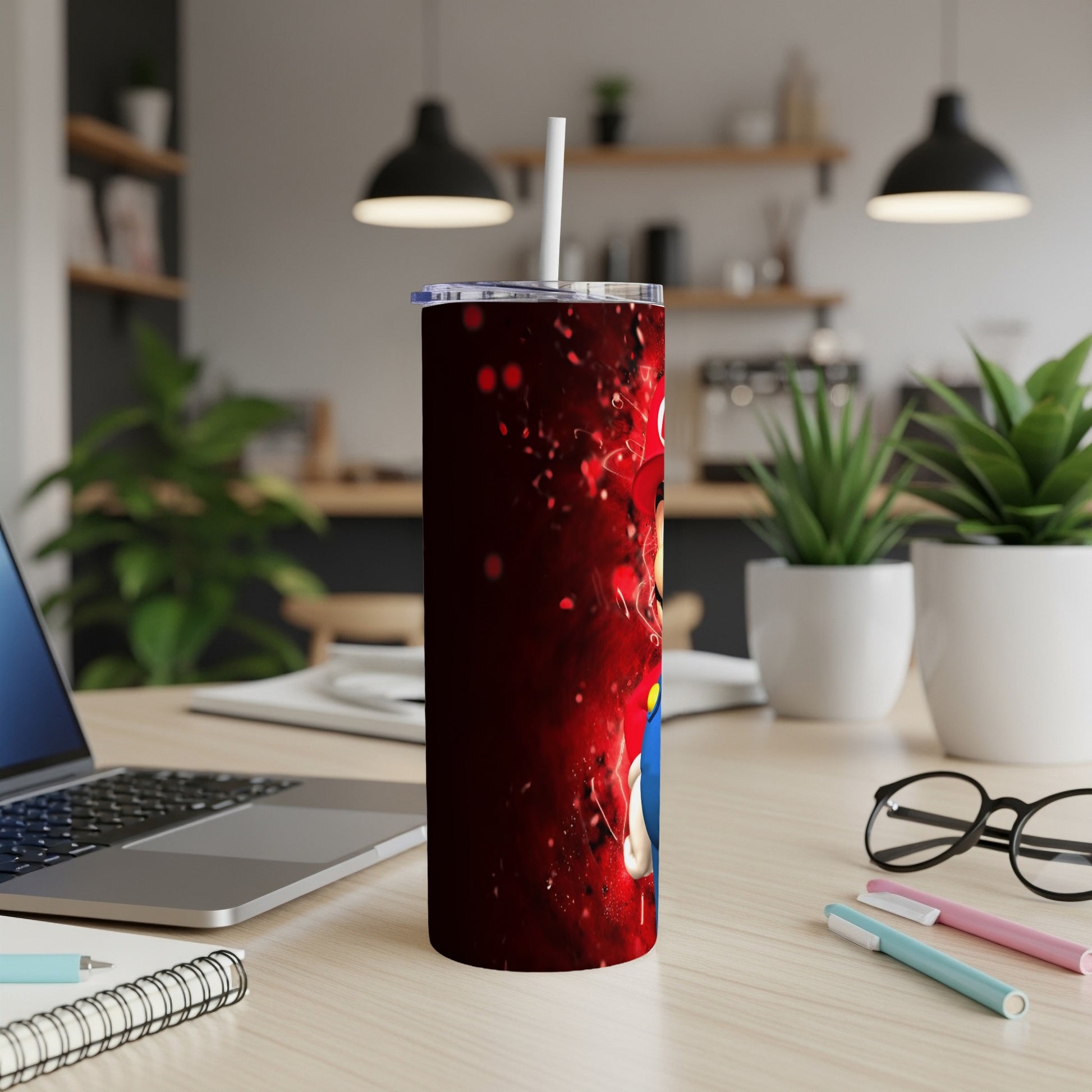 Red tumbler with cartoon character on a desk.