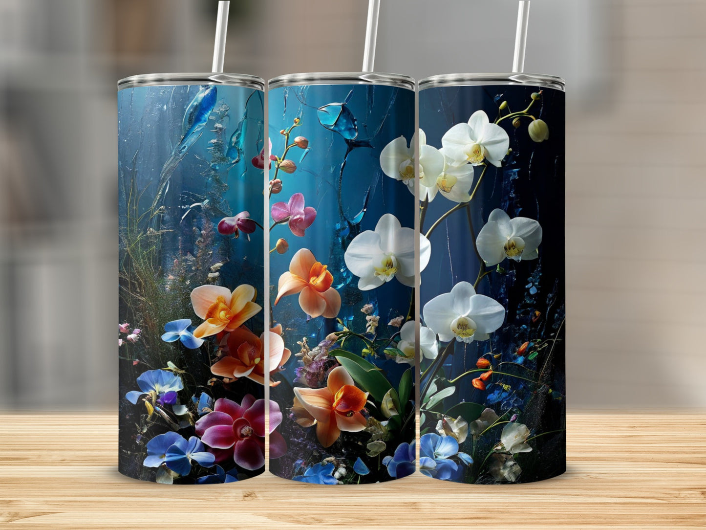 Three tumblers featuring colorful orchids and abstract blue floral designs.