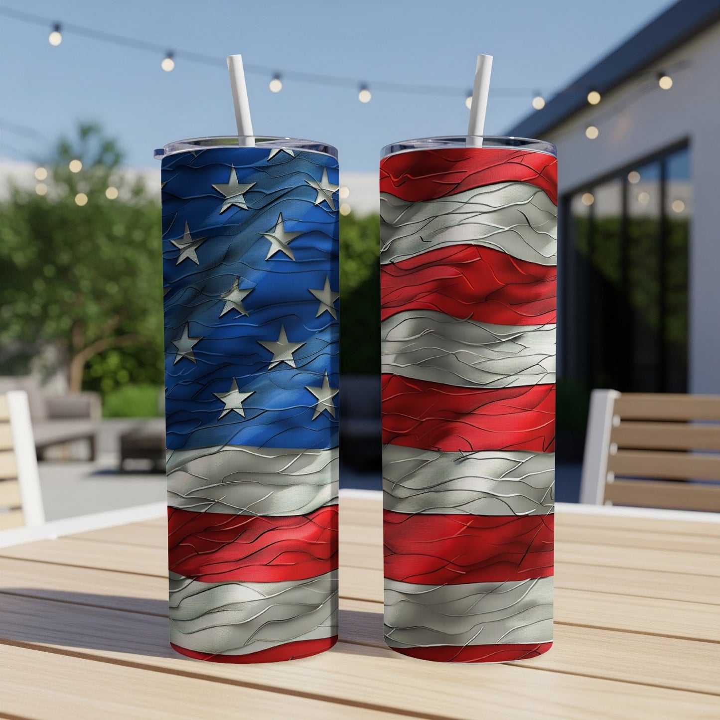 Two tumblers with American flag design on wooden table outdoors.
